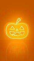 Pumpkin in neon on orange background with space for text. Halloween concept. photo