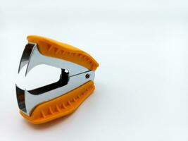 Orange Staple Remover Isolated On White Background. Three Quarters View With Negative Space photo