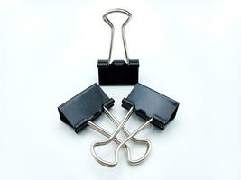 Three Binder Clips Isolated On White Background. One Standing And Two Laying photo