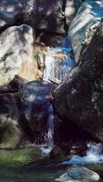 Water flows between stones at the Kalmtal waterfall, Passeier, Val Passiria, South Tyrol, Italy video