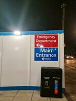 Low Angle Illuminated View of Emergency Entrance of Luton and Dunstable Hospital at Luton City of England UK During Midnight of Sep 3rd, 2023. Hospital's Building is Under construction for Renovation photo