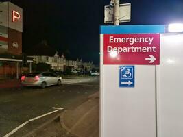 Low Angle Illuminated View of Emergency Entrance of Luton and Dunstable Hospital at Luton City of England UK During Midnight of Sep 3rd, 2023. Hospital's Building is Under construction for Renovation photo