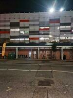 Low Angle View of Illuminated Road and Car Park Building Opposite of Luton and Dunstable Hospital at Luton City of England UK During night of Sep 3rd, 2023. photo