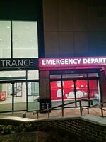 Low Angle Illuminated View of Emergency Entrance of Luton and Dunstable Hospital at Luton City of England UK During Midnight of Sep 3rd, 2023. Hospital's Building is Under construction for Renovation photo