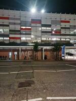 Low Angle View of Illuminated Road and Car Park Building Opposite of Luton and Dunstable Hospital at Luton City of England UK During night of Sep 3rd, 2023. photo
