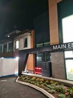 Low Angle Illuminated View of Emergency Entrance of Luton and Dunstable Hospital at Luton City of England UK During Midnight of Sep 3rd, 2023. Hospital's Building is Under construction for Renovation photo