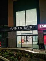 Low Angle Illuminated View of Emergency Entrance of Luton and Dunstable Hospital at Luton City of England UK During Midnight of Sep 3rd, 2023. Hospital's Building is Under construction for Renovation photo