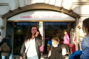 Beautiful Low Angle Image of People at Central London capital City of England Great Britain, Most of the Tourist are International from Many Communities of World. Image Captured on August 2nd, 2023 photo