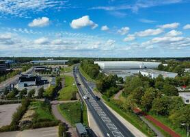 High Angle Footage of British Road and Traffic at Caldecotte Lake of Milton Keynes City of England Great Britain, Beautiful View Captured on August 21st, 2023 with Drone's Camera During Sunny Day photo