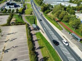 High Angle Footage of British Road and Traffic at Caldecotte Lake of Milton Keynes City of England Great Britain, Beautiful View Captured on August 21st, 2023 with Drone's Camera During Sunny Day photo