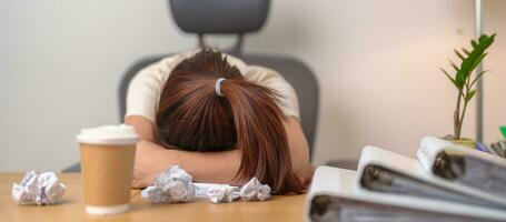 Stressed Asian woman having Tired and Sleepy while working, female businesswoman having headache at office, Exhausted woman with documents folder stack at home late night. Overworked and Overtime photo