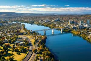 aéreo ver de el ciudad de perth, occidental Australia. aéreo zumbido panorámico ver mirando a victoria puente terminado el waikato río como eso cortes mediante el ciudad de hamilton, ai generado foto