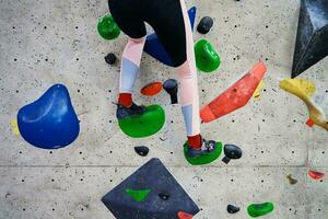 Woman training at bouldering gym. Active recreation, sports exercises photo