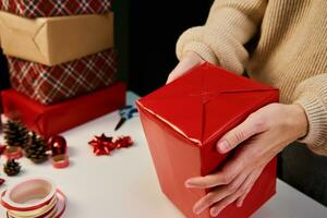 Woman packaging gift box in craft paper, Present for christmas surprise photo