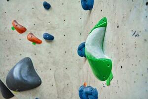 Bouldering gym with artificial colourful rock wall photo