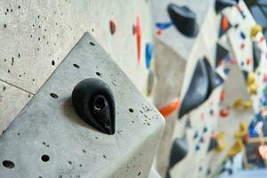 Bouldering gym with artificial colourful rock wall photo