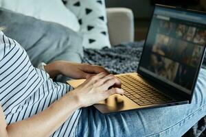 Woman hands typing on laptop keyboard photo