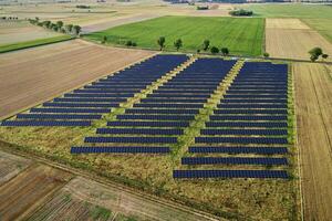 Solar energy production using solar battery panels in field, view from above photo