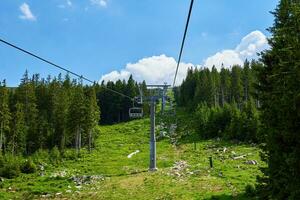 Open cable car line in mountains, Ski lify in resort for tourists photo