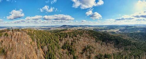 Drone flight over mountains covered with forest and valleys photo