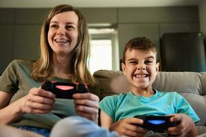 Boy and woman playing video game at home photo