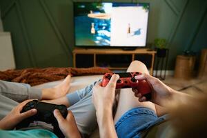 Boy and man playing video game at home photo