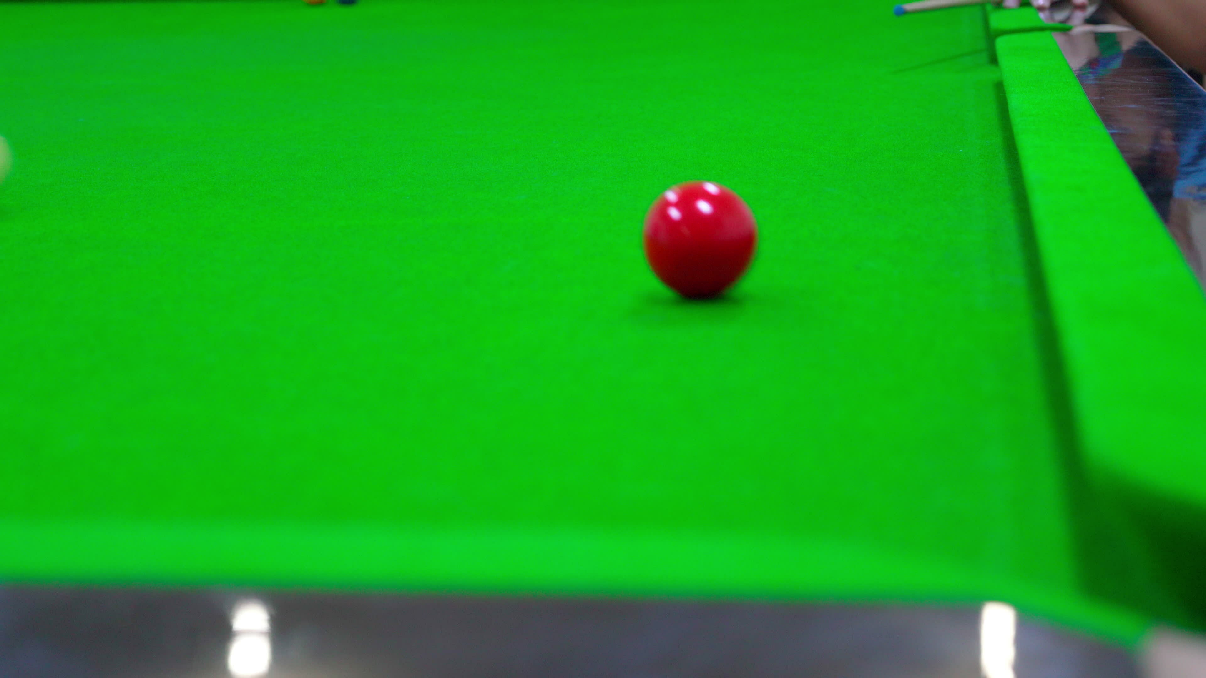 Shoot the white ball to hit the red ball into the hole.Game of snooker