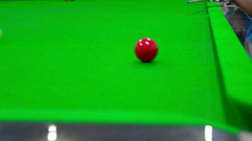 Shoot the white ball to hit the red ball into the hole.Game of snooker ,playing a snooker game hit a target ball into the corner pocket ,cue ball striking balls ,indoor sport concept.. video