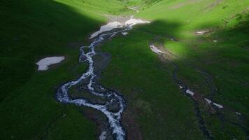 Panoramic aerial view of summer mountain valley landscape with green forest, mountain river and sky with clouds video