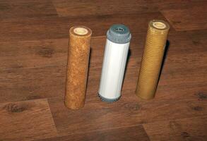 Used water filters with traces of dirt, clay and impurities. Replacing multi-stage water filter cartridges. photo