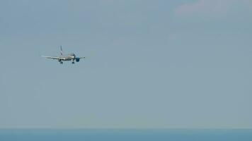 SOCHI, RUSSIA JULY 28, 2022 - Long shot of passenger plane Airbus A321 Aeroflot approaching before landing at Sochi airport. Airplane flight, arrival. Tourism and travel concept video