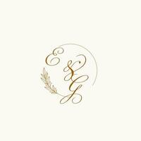Initials EG wedding monogram logo with leaves and elegant circular lines vector