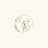 Initials EO wedding monogram logo with leaves and elegant circular lines vector