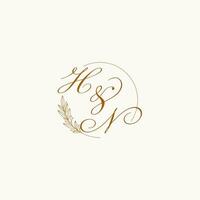 Initials HN wedding monogram logo with leaves and elegant circular lines vector