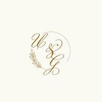 Initials UG wedding monogram logo with leaves and elegant circular lines vector