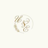 Initials UE wedding monogram logo with leaves and elegant circular lines vector