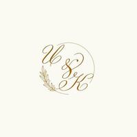 Initials UK wedding monogram logo with leaves and elegant circular lines vector