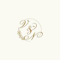 Initials VN wedding monogram logo with leaves and elegant circular lines vector