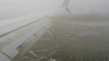 POV view from the porthole during takeoff and climb. Airliner flies through the clouds video