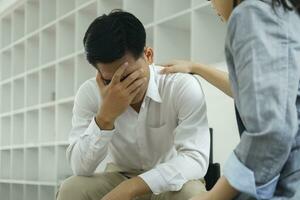 Psychiatrist or counselor holding the patient's hand to comfort and encourage. photo