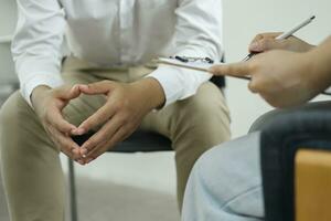 Psychiatrist or counselor holding the patient's hand to comfort and encourage. photo