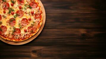 Pizza on a wooden background. Top view with copy space. photo