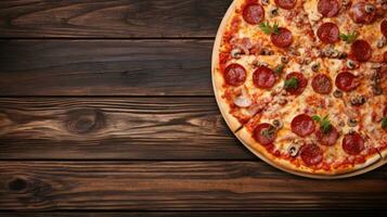 Pizza on a wooden background. Top view with copy space. photo