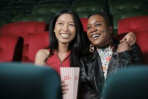 Couple of Black female audiences and lovers express emotion, watching funny cinema together, laughing at movie theater, and entertaining lifestyle with romance film show with happy and cheerful smile. photo