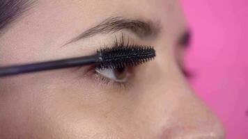 Close up of Woman applying rimmel on eyelash - make up video