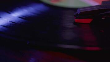 Close up of a Vinyl Record player Spinning with cinematic red and blue lighting video