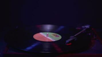 Close up of a Vinyl Record player Spinning with cinematic red and blue lighting video