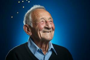 Senior man smiling happily on blue background photo