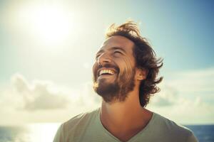 happy young man with backpack looking to the sky photo