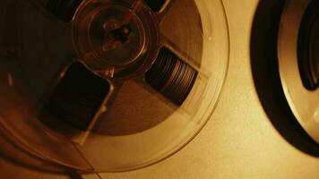 An old audio tape reel spinning. Sound magnetic tape. video